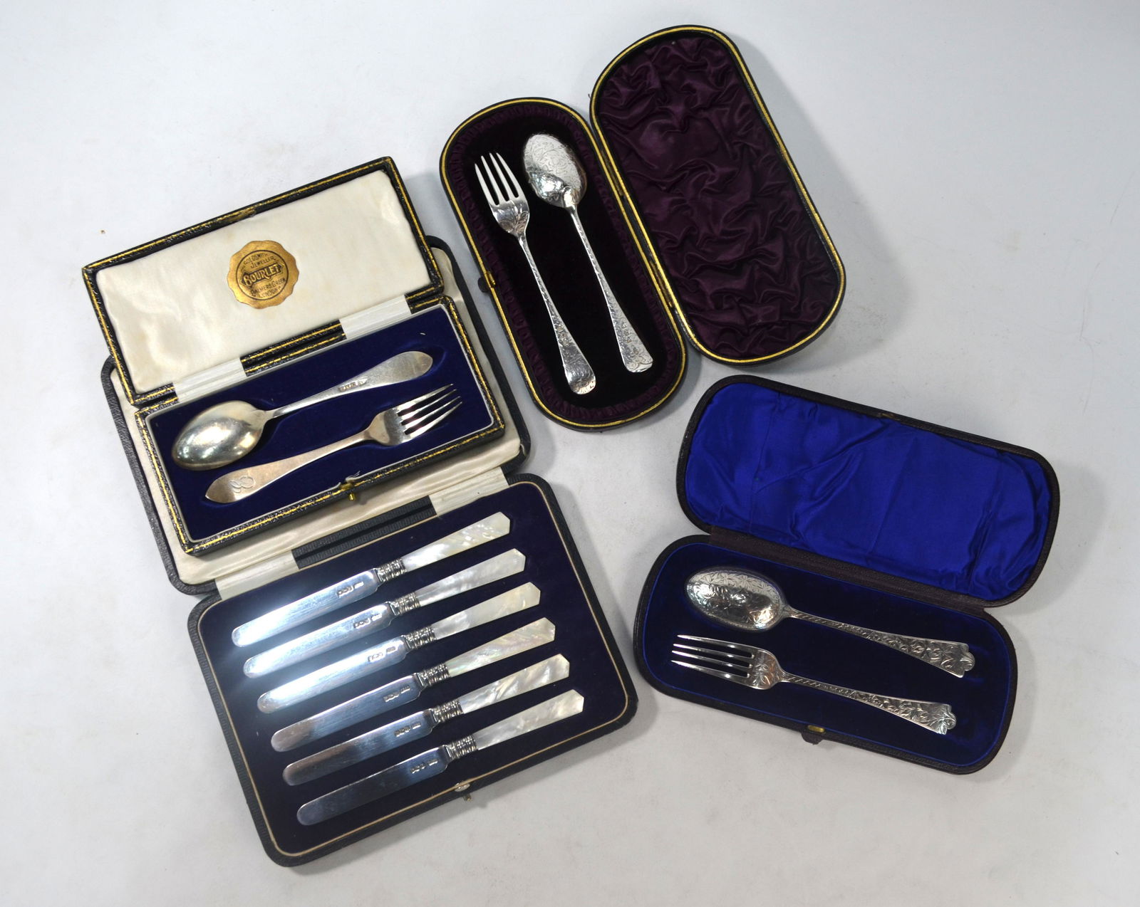 Cased set of silver tea-knives etc.: A cased set of six silver tea-knives with carved mother-of-pearl handles, James Dixon & Son, Sheffield 1922, to/w two Victorian cased Christening spoons and forks and a later cased spoon and fork, Lon