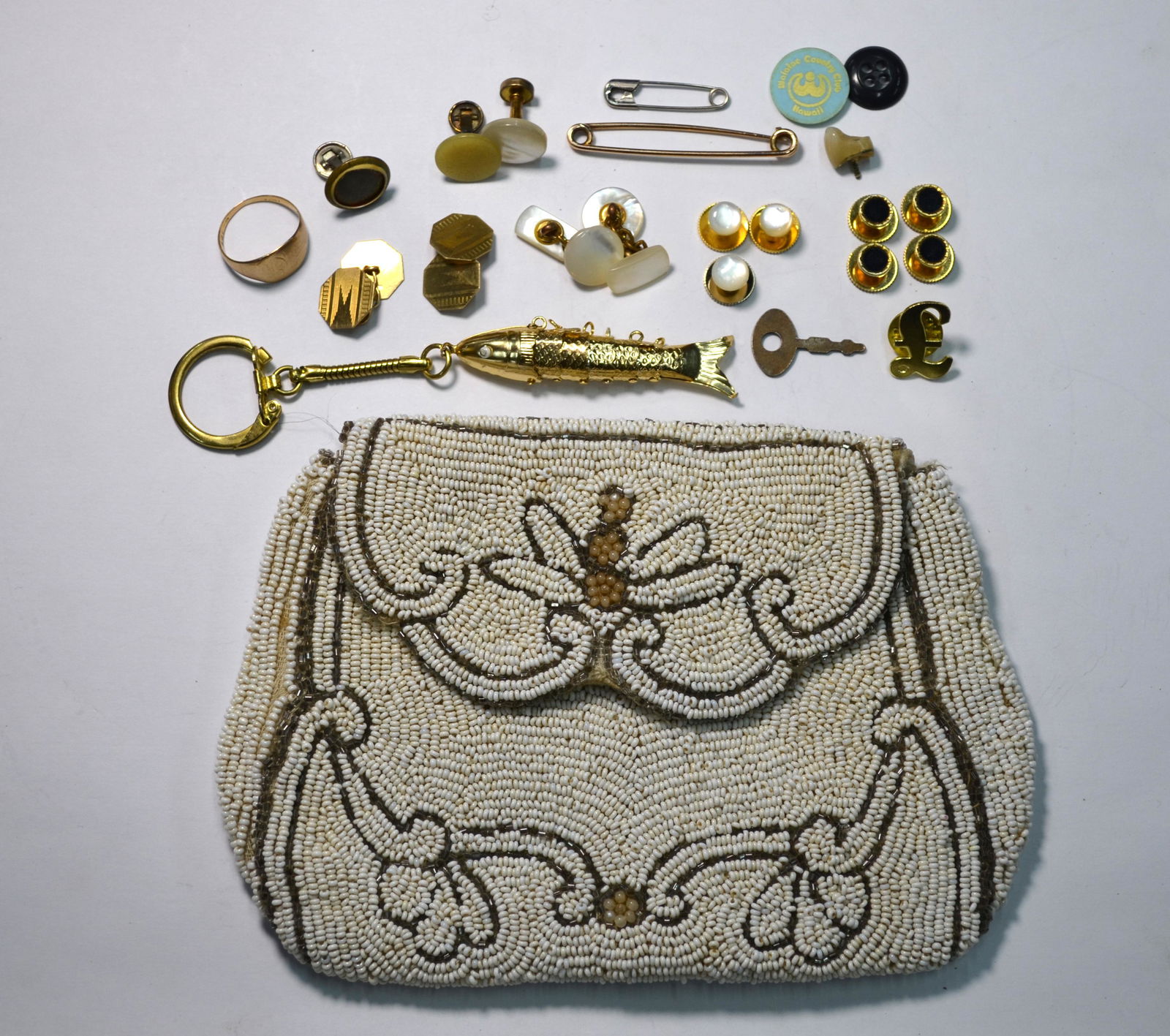 A pair of 9ct yellow gold cufflinks and other items: A pair of 9ct yellow gold octagonal chain linked cufflinks with engine turned decoration, a 9ct yellow gold signet ring and a yellow gold safety pin, approx 8.7g to/w articulated fish key ring, variou