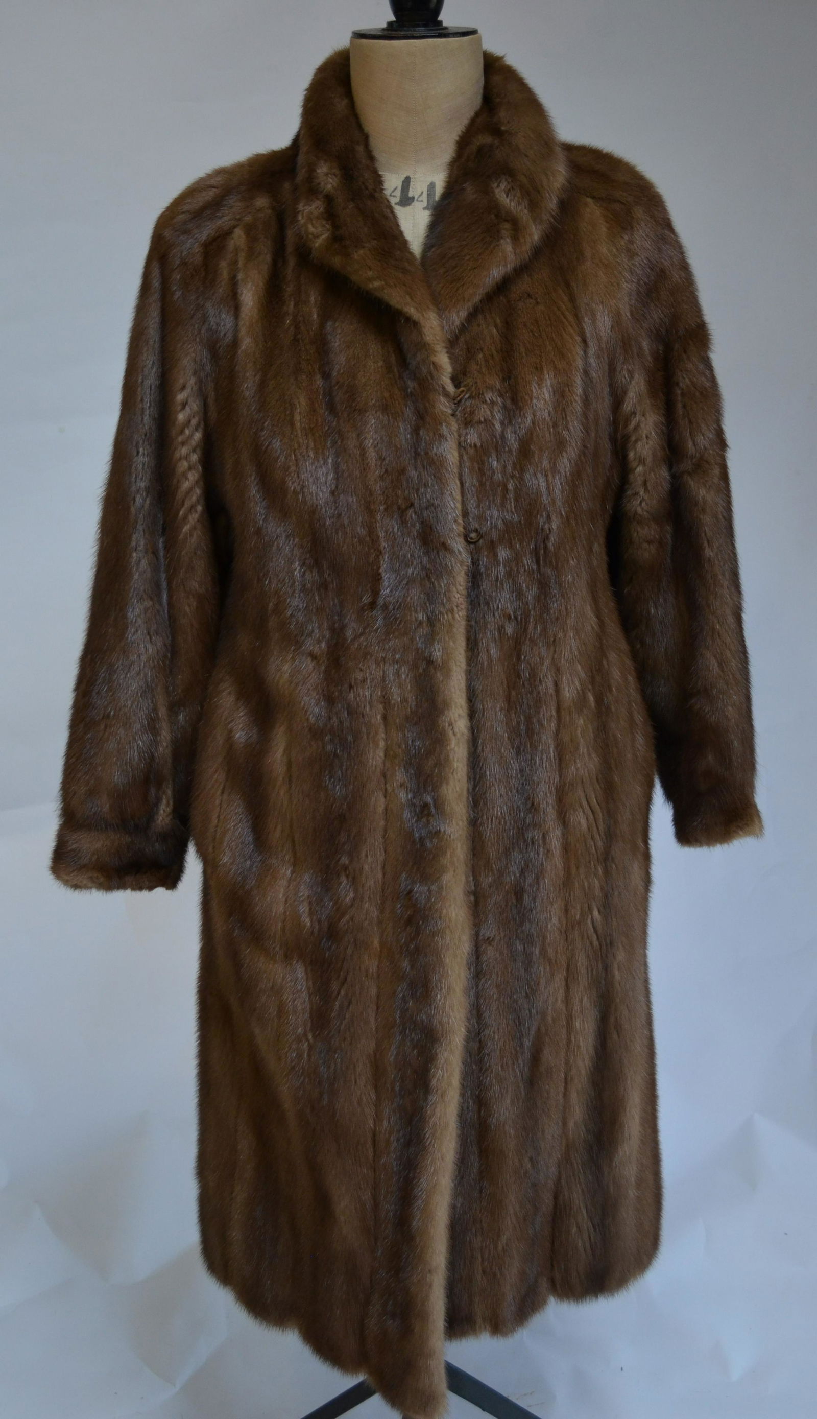 Christian Dior Fourrures full-length mink coat: A Christian Dior Fourrures full-length mid-brown mink coat with label for Caton & monogrammed badges N K C, with neat collar and shaped sleeves to cuff, 56 cm across chest