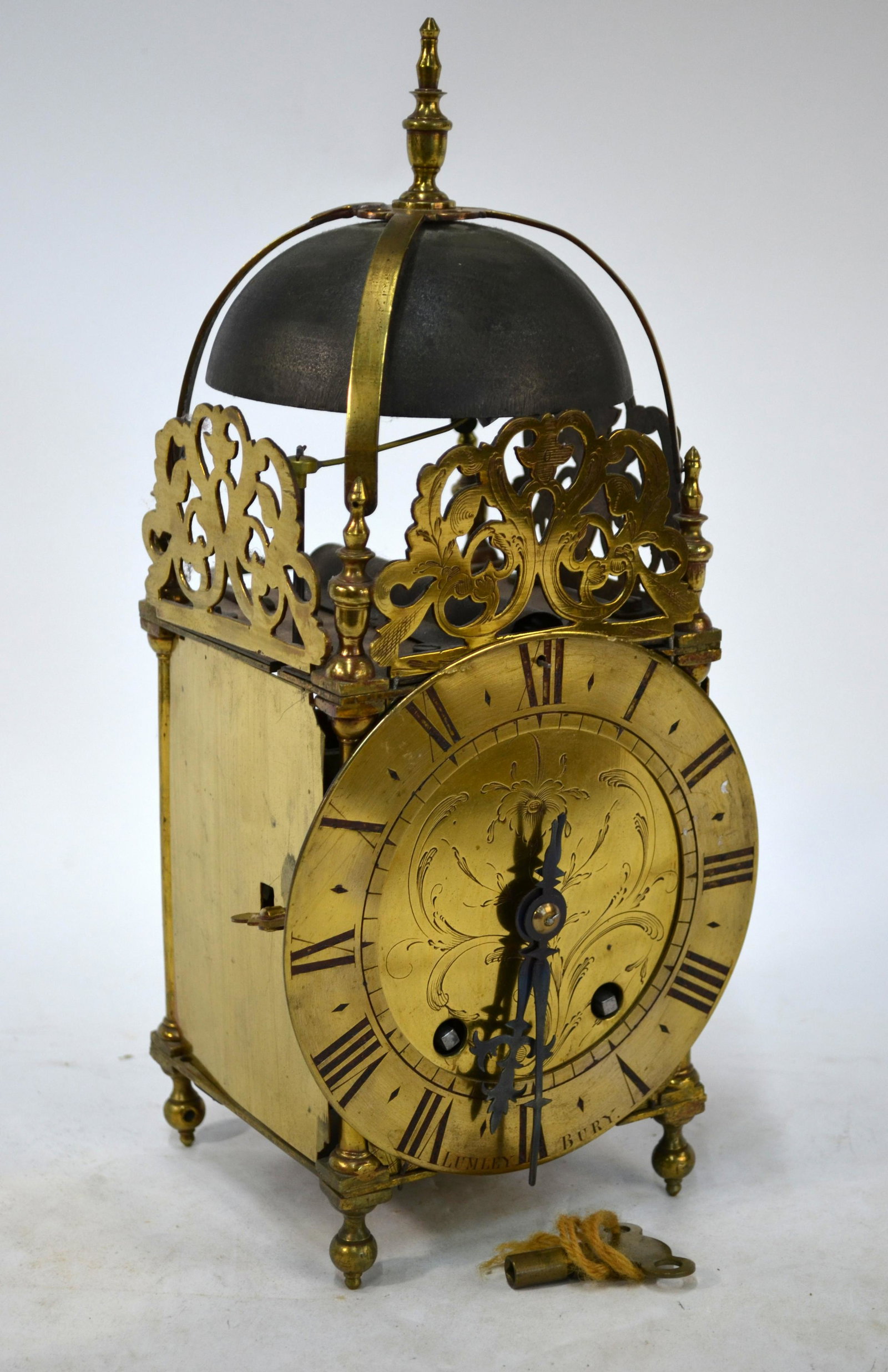 Lumley, Bury (signed) a two train 17th century style: Lumley, Bury (signed) a two train 17th century style brass lantern clock with French movement, the engraved brass dial beneath a bell striking the hours and half hours, 35 cm h