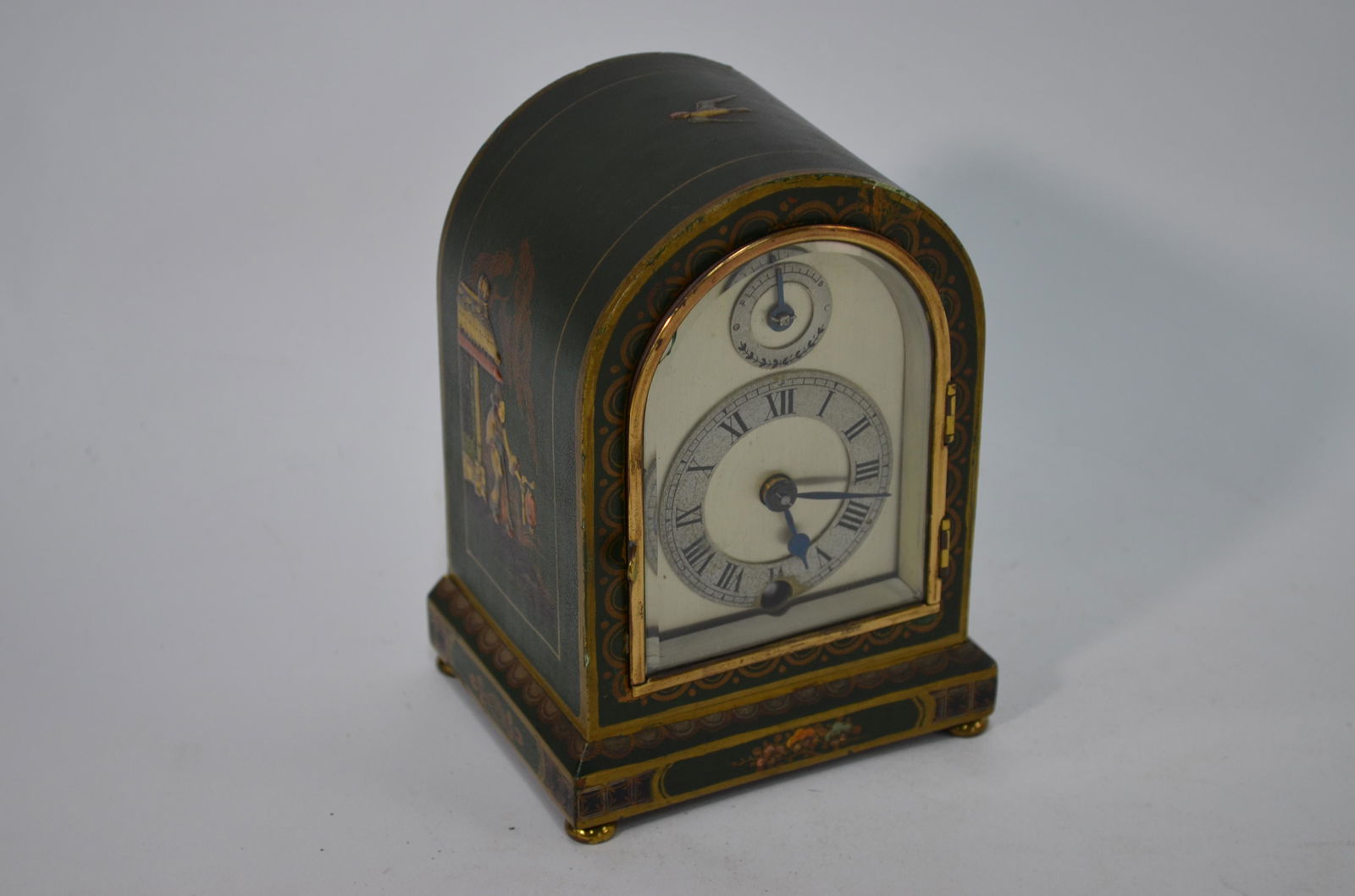 Astral, a vintage green chinoiserie cased clock: Astral, a vintage green chinoiserie cased clock with silvered arched dial, 15.5 cm high a/f