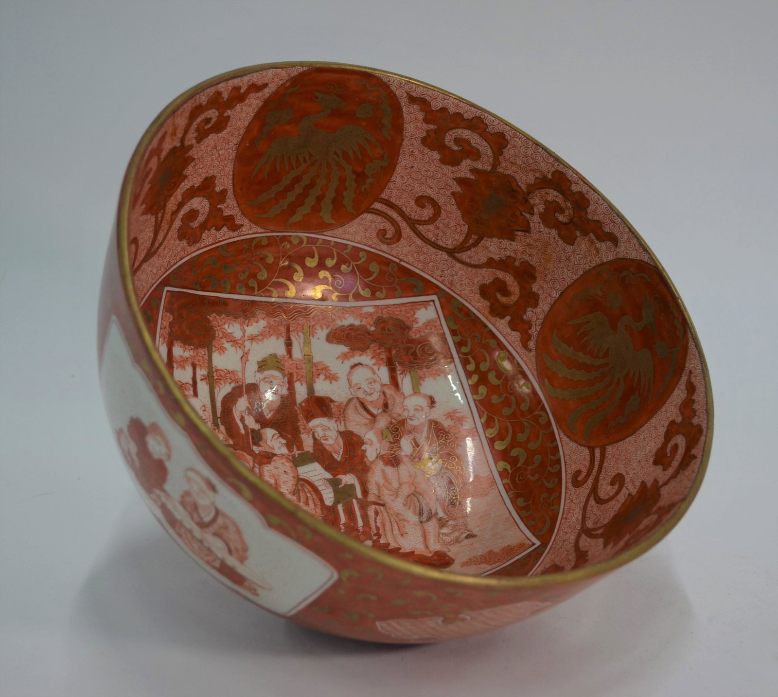 A 19th century Japanese Kutani bowl: A 19th century Japanese Kutani bowl, Meiji period (1868-1912) painted in iron red and gilt detail, the various reserves with scenes depicting elders and attendants discussing philosophy, the interior 