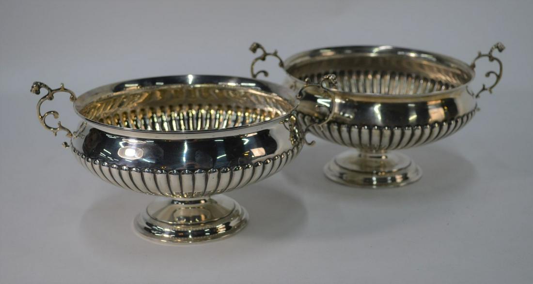 A pair of Victorian half-reeded silver circular bowls: A pair of Victorian half-reeded silver circular bowls with twin scroll handles, on stemmed circular foot, Charles Stuart Harris, London 1886, 27 oz