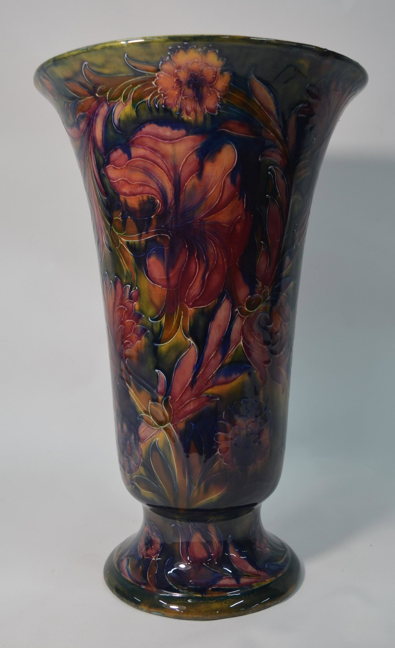 A large and impressive William Moorcroft pedestal vase: A large and impressive William Moorcroft pedestal vase of bell form, decorated with the 'Spanish' pattern, mottled green ground, impressed Corbridge factory mark and painted signature, c. 1918-29, 42.