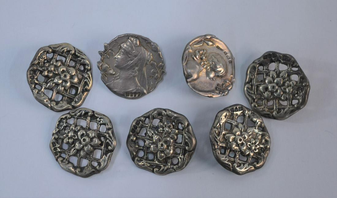 Collection of Edwardian buttons: Five Edwardian silver buttons, cast and pierced with floral decoration, Birmingham 1907, to/w two other buttons with female relief profiles, London import 1902 and Birmingham 1902