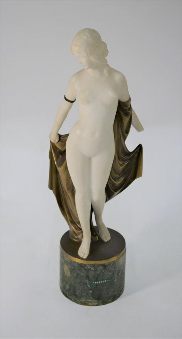 An Art Deco gilt bronze and alabaster figure of 'Phryne: An Art Deco gilt bronze and alabaster figure of 'Phryne, female nude removing her cloak, on cylindrical marble plinth, unsigned, 44 cm high overall (one hand missing)