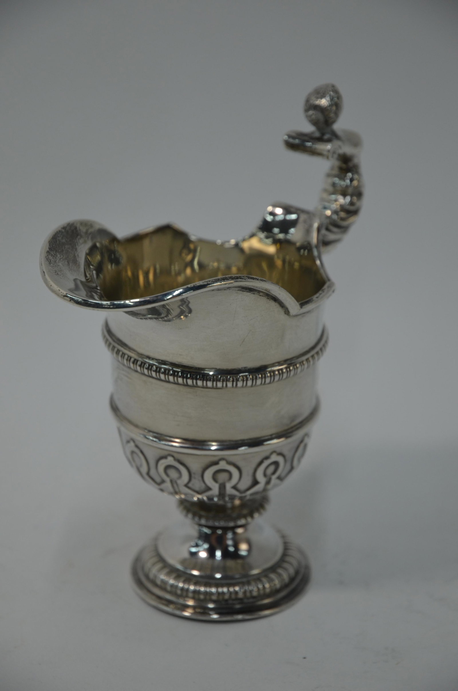 A good quality silver cream jug: A good quality silver cream jug in the form of a Baroque ewer with cast finial handle, on stemmed foot, Birmingham 1916, 5.7 oz, 13 cm high