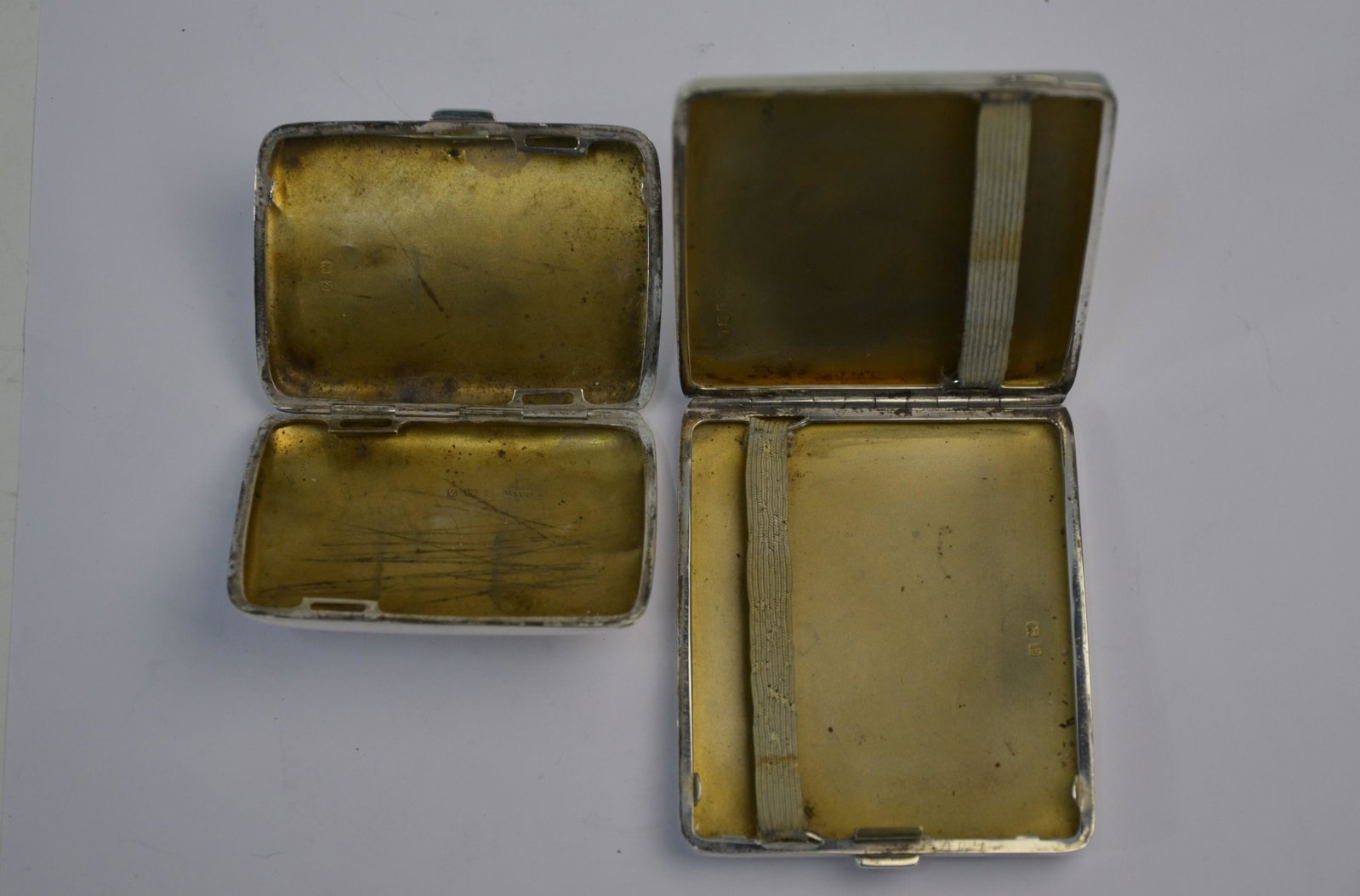 Two silver cigarette cases: A heavy quality silver cigarette case, William Neale & Son Ltd, Birmingham 1929 to/w a hip-pocket cigarette case, Birmingham 1924 (2) 6.6 oz