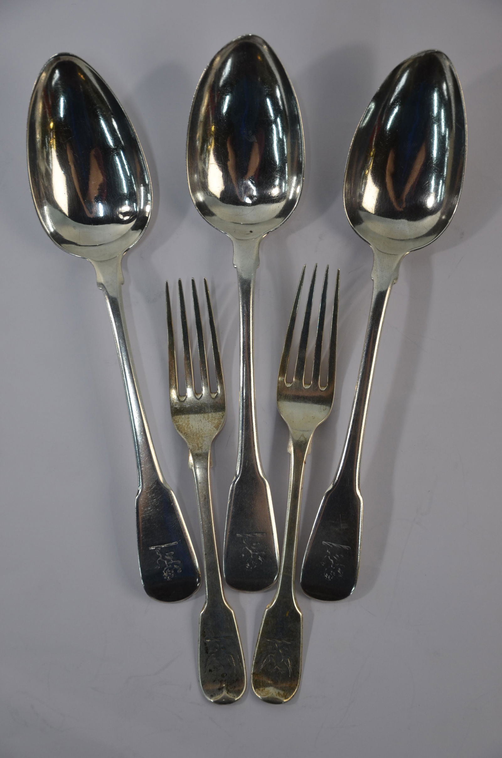 Three George III silver fiddle pattern table spoons and: Three George III silver fiddle pattern table spoons, maker W.E., London 1809 to/w a similar pair of dessert spoons, John William Blake, London 1824 (5) 9.8 oz