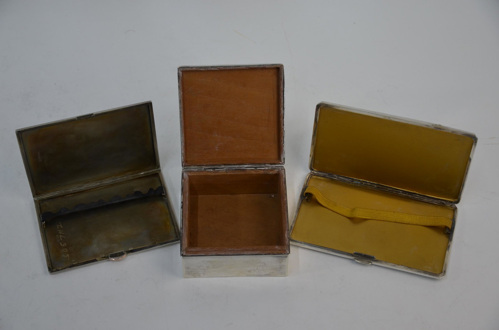 A heavy quality Art Deco silver cigarette case, epns: A heavy quality Art Deco silver cigarette case with engine-turned decoration inset with gold band, Walker & Hall, Sheffield 1941, 6.3 oz to/w a somewhat similar epns example and a silver cigarette box