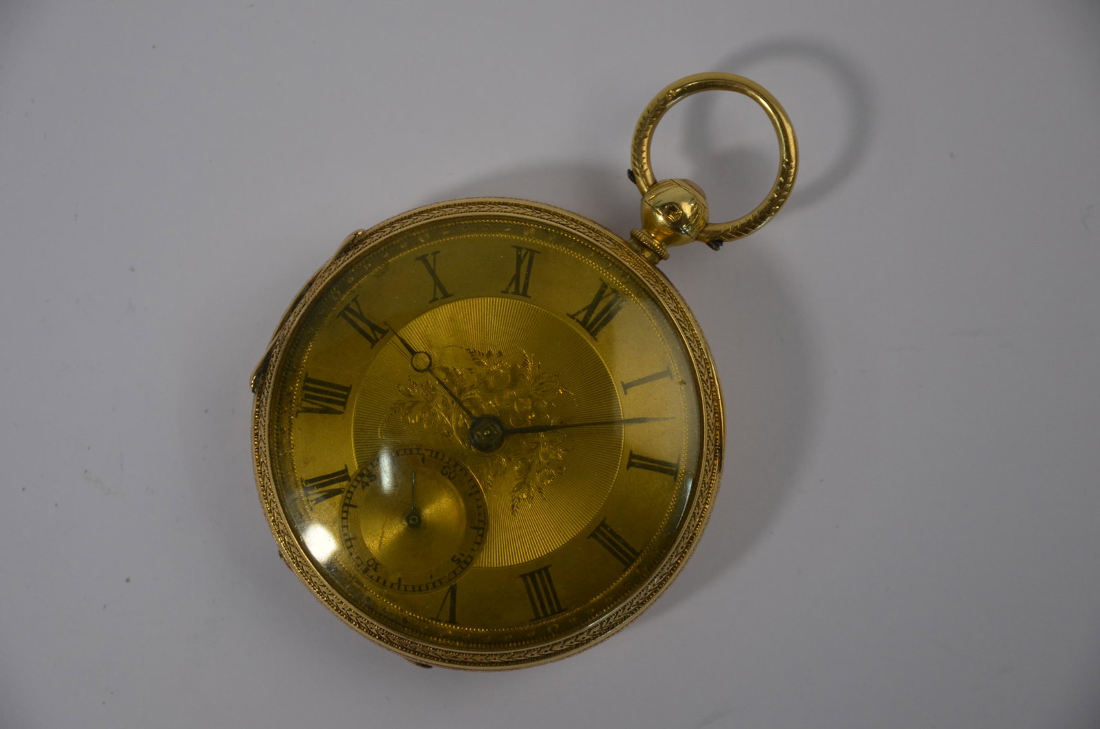 A Victorian 18ct gold open-faced pocket watch: A Victorian 18ct gold open-faced pocket watch with floral engraved 45 mm dial with key-wind lever movement no.20458, un-named, the case Chester 1876