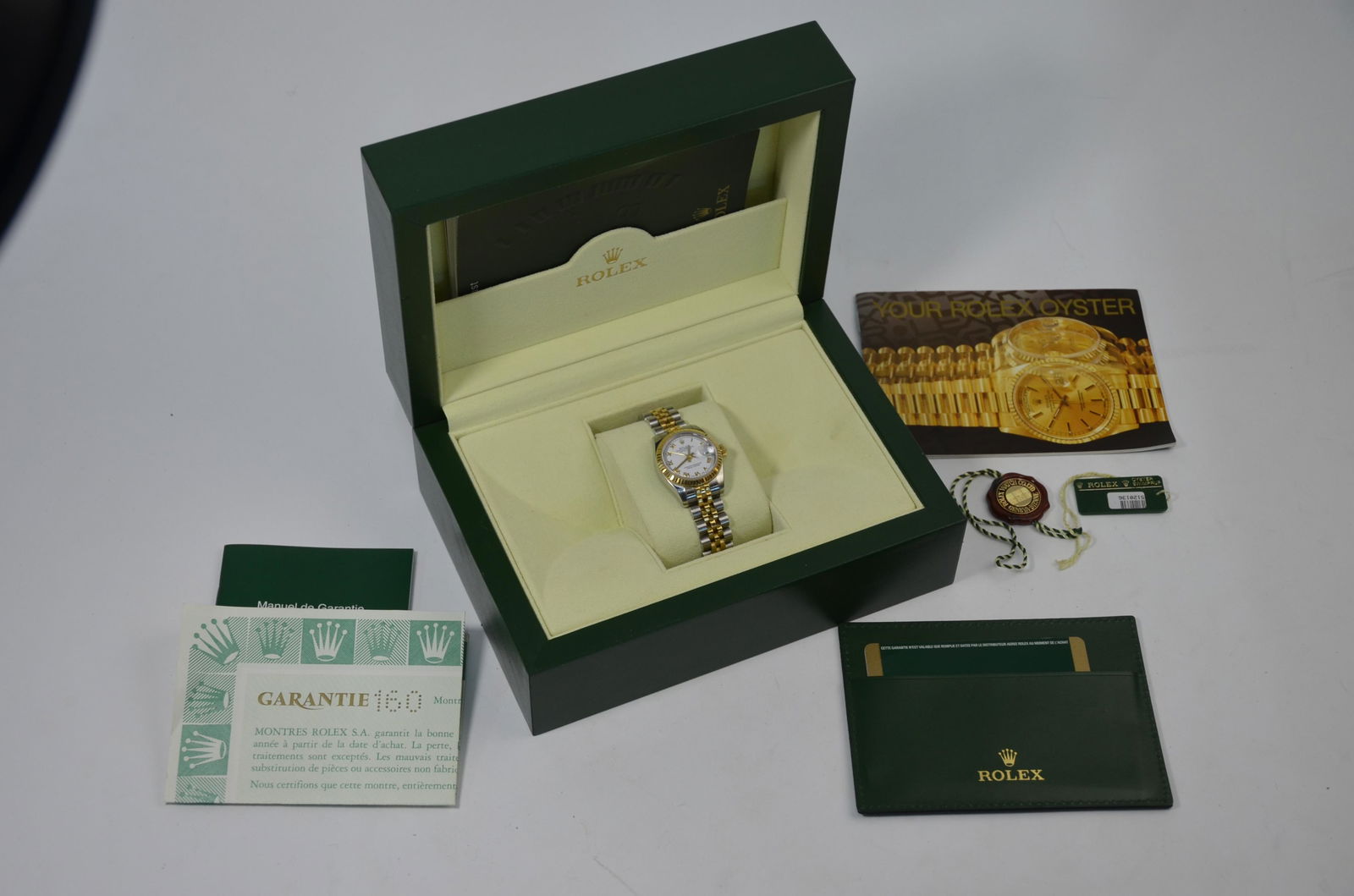 A Lady's Rolex stainless steel and gilt Oyster: A lady's Rolex stainless steel and gilt Oyster Perpetual Datejust Superlative Chronometer wristwatch, Series no. M988615, model 179173, with original boxes and paperwork (2011)