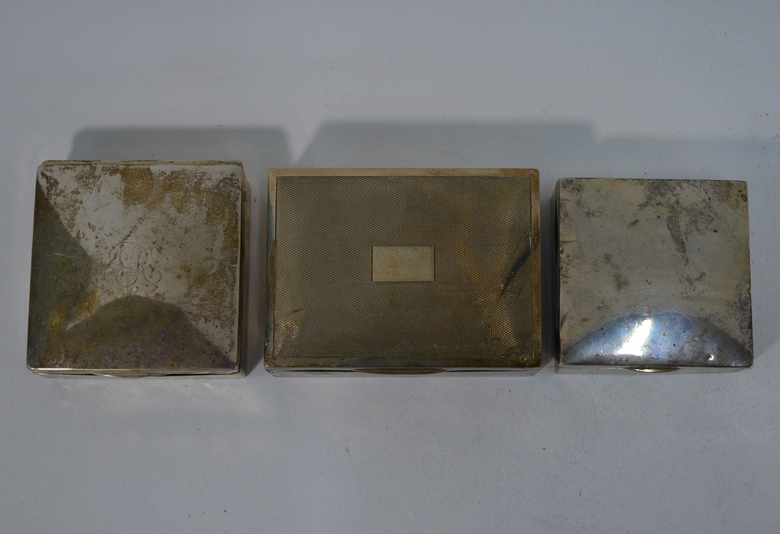 Three various silver cigarette boxes: Three various silver cigarette boxes (a/f)