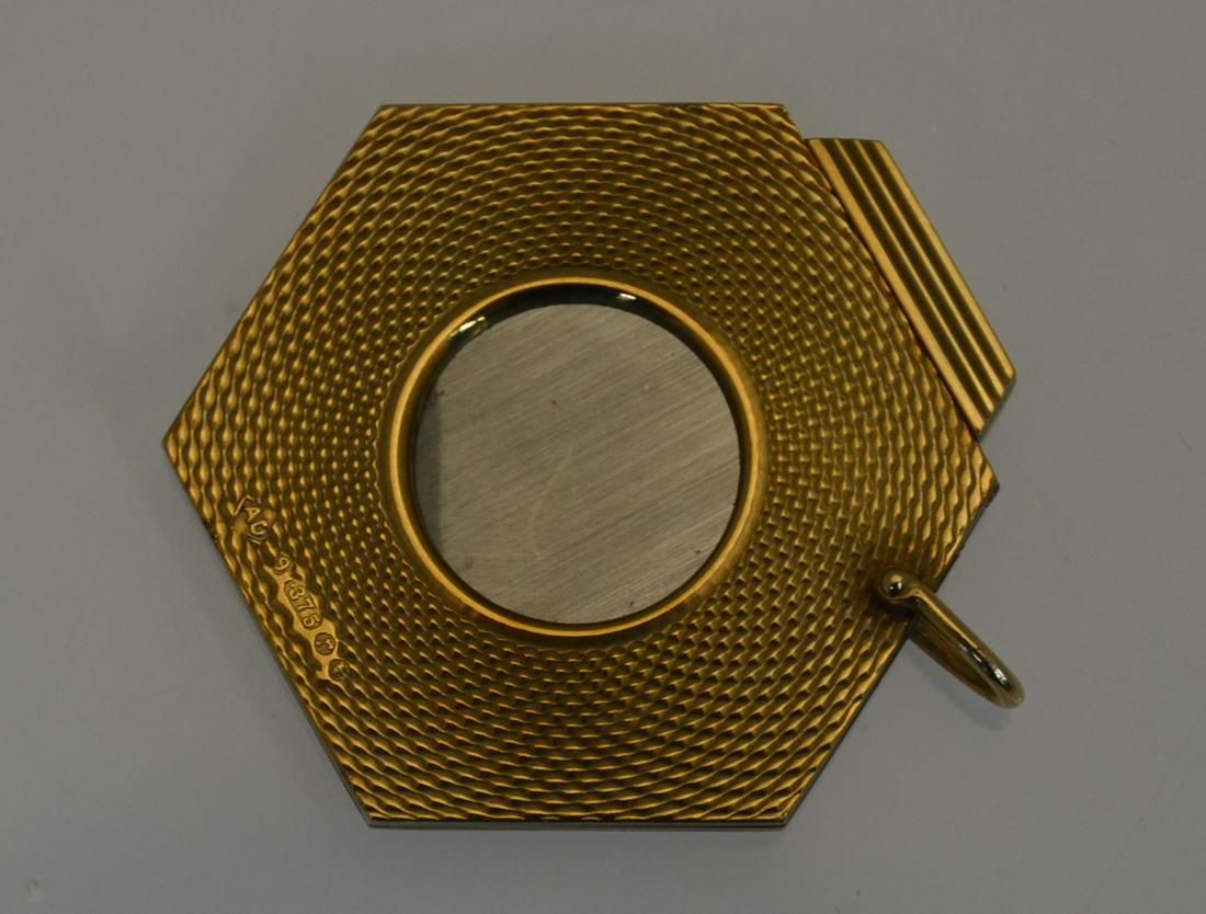 Dunhill cigar cutter: Dunhill - A 9ct yellow gold hexagonal cigar cutter with engine-turned decoration and guillotine action, 3.8 cm diam, suspension loop