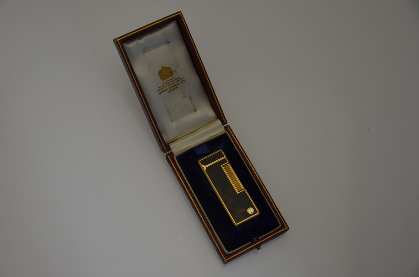 A Dunhill tortoiseshell-style cigarette lighter: Dunhill - A rollagas tortoiseshell-style cigarette lighter, cased