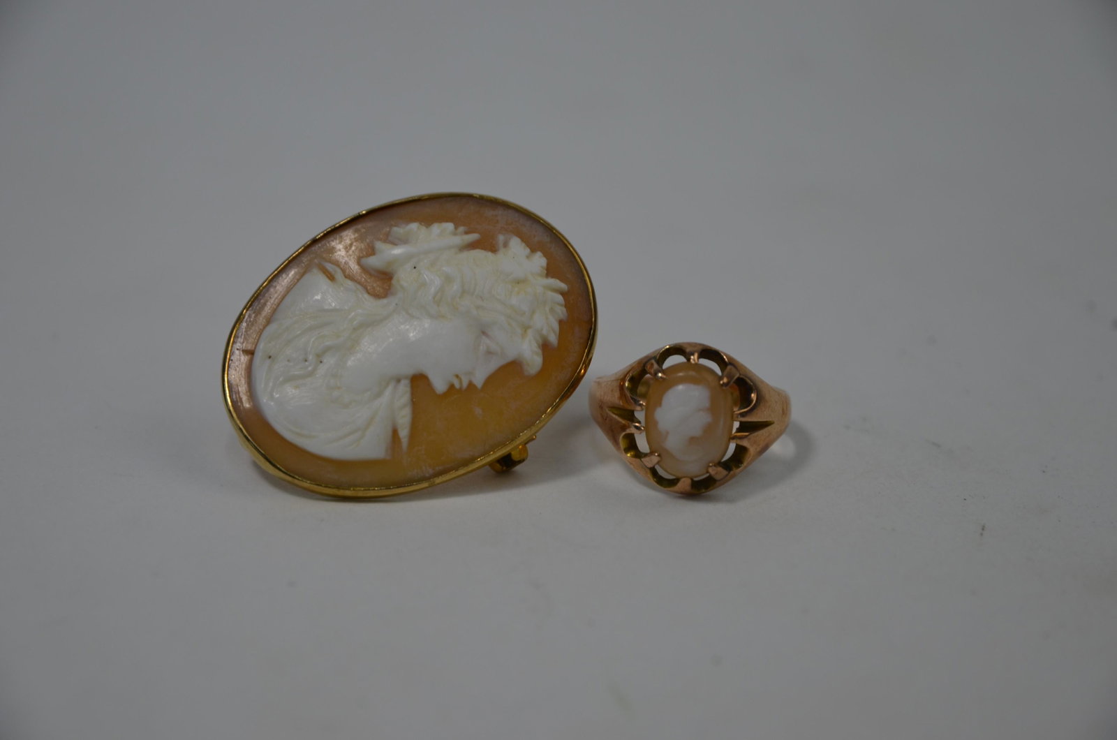 An oval shell cameo brooch: An oval shell cameo brooch featuring classical bust of a lady, yellow metal set to/w 9ct yellow gold claw set ring set with small oval cameo (2)