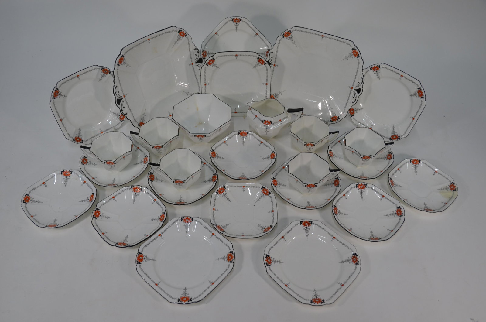 A Shelley china Queen Anne shape tea service: A Shelley china Queen Anne shape tea service, decorated with the 'Red Daisy' pattern, comprising six tea cups, ten saucers, six tea plates, two sandwich plates, milk and sugar pair (26 pieces)