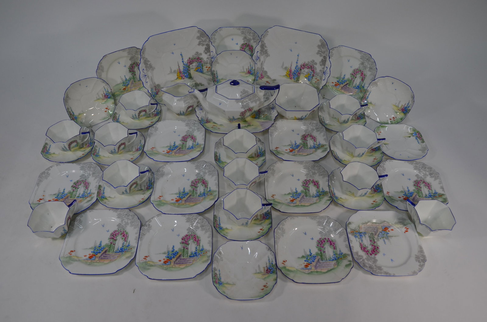 A Shelley china Queen Anne shape tea service: A Shelley china Queen Anne shape tea service, decorated with the Archway of Roses pattern, comprising twelve each tea cups, saucers and plates, two sandwich plates, teapot, milk and sugar (41 pieces)