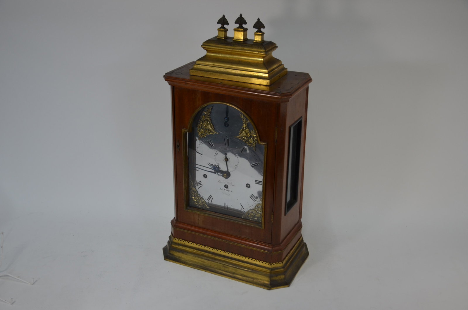 William Withers, London, a George III three train: William Withers, London, a George III bracket clock, the three train musical movement striking on a rack of eight bells and principal bell, with engraved backplate, the (polished) arched dial with str