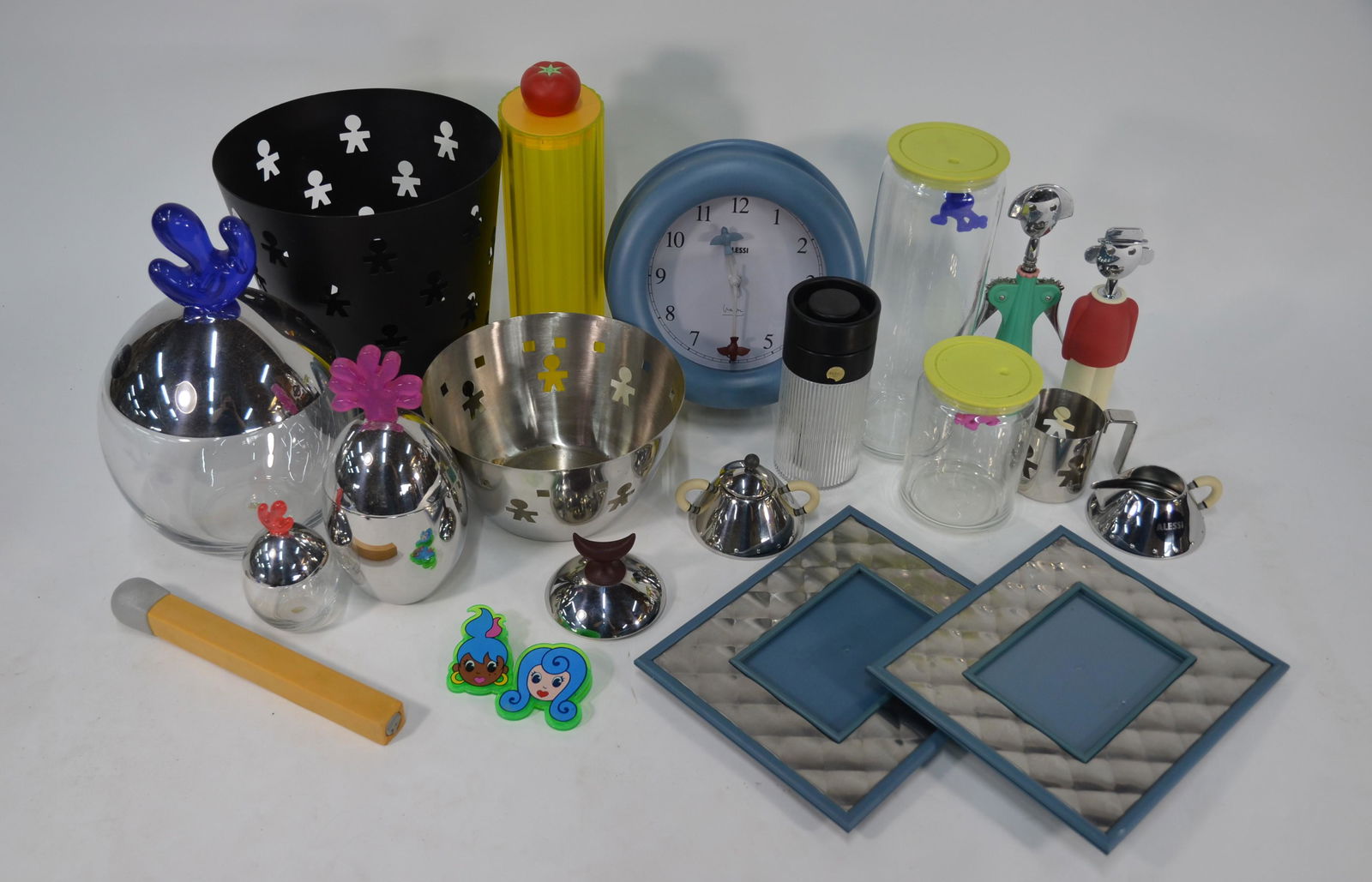 A collection of Alessi kitchenalia: A collection of mostly unused modern Alessi kitchenalia including a 'Big Ovo' crystalline glass and stainless steel biscuit box, blue circular wall clock, pair of rectangular photograph frames, 'Anna
