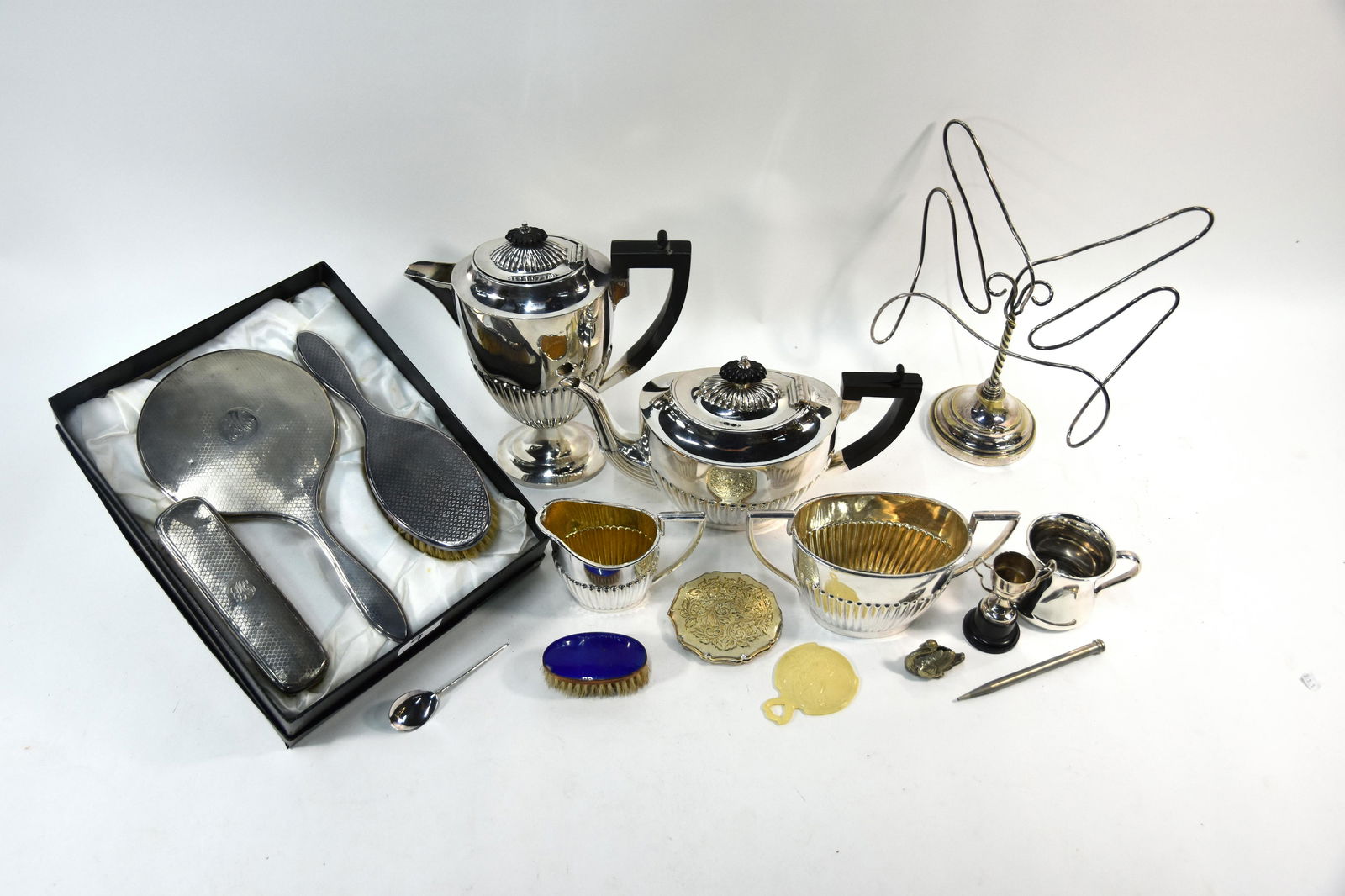 A silver-backed hand mirror with two brushes and epns: A silver-backed hand mirror with two brushes (not a set), an epns lectern/menu stand with bent wire frame on circular foot, 27 x 22 cm overall to/w an epns four piece half-reeded tea/coffee service, c