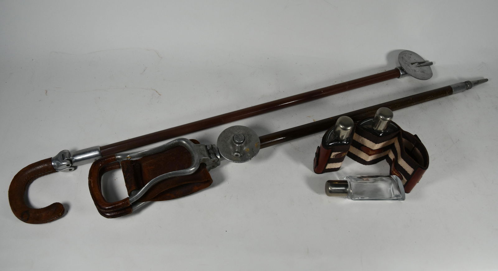 Two shooting sticks with folding seats and a: Two shooting sticks with folding seats and a three-bottle spirit flask set in leather case (3)