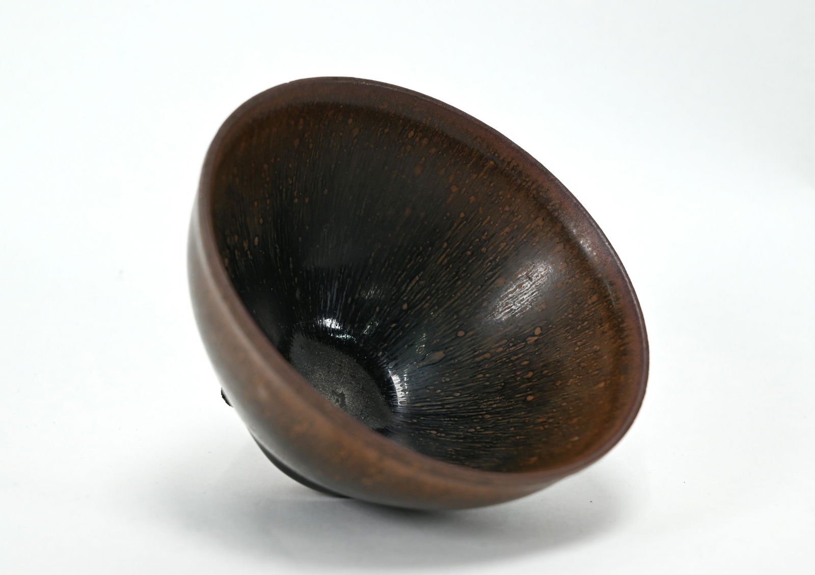 A Chinese Jian Yao 'hares fur' tea bowl, Southern Song: A Chinese Jian Yao 'hares fur' tea bowl, Southern Song style, the thick unctuous black glaze with irregular russet markings stopping short of an unglazed brown stoneware foot, 12.5cm diam x 7 cm high