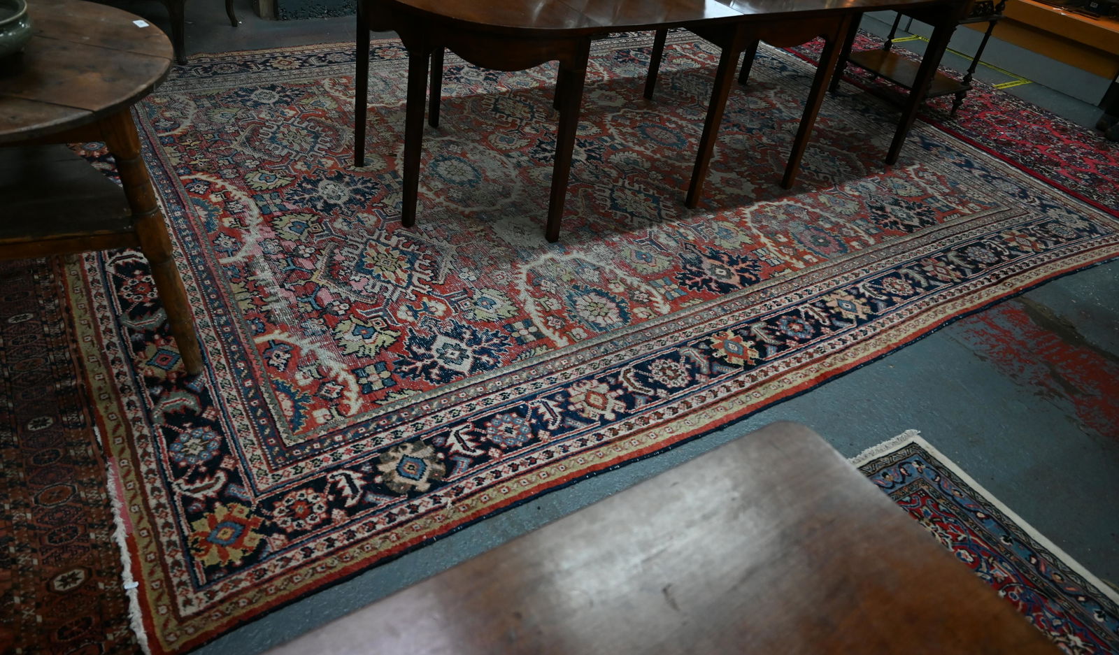 An antique Persian Mahal / Heriz carpet: An antique Persian Mahal / Heriz carpet, heavily worn overall, 366 cm x 270 cm
