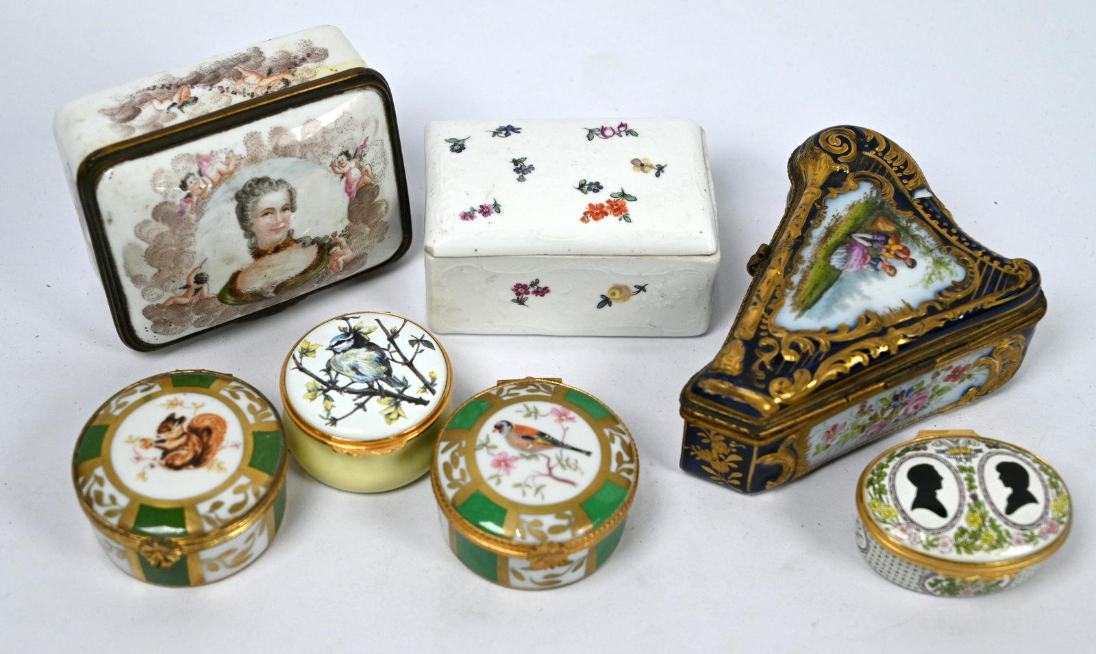 A 19th century Sevres porcelain harp-shaped trinket-box: A 19th century Sevres porcelain harp-shaped trinket-box, the reserves painted with a courting couple and sprays of flowers on a gros bleu ground, 10.5 cm wide to/w another Continental porcelain box, p