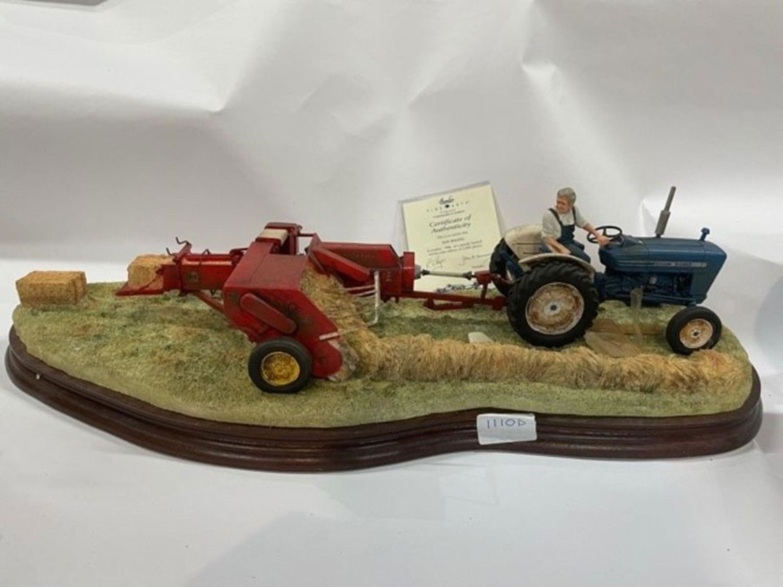 Border Fine Arts 'Hay Baling' (B0738) a Ford 2000: Border Fine Arts 'Hay Baling' (B0738) a Ford 2000 tractor and baler sculpture by Ray Ayres, limited edition No. 796 of 2002, on wood base, with box and certificate Buyers premium 30% (inc VAT)