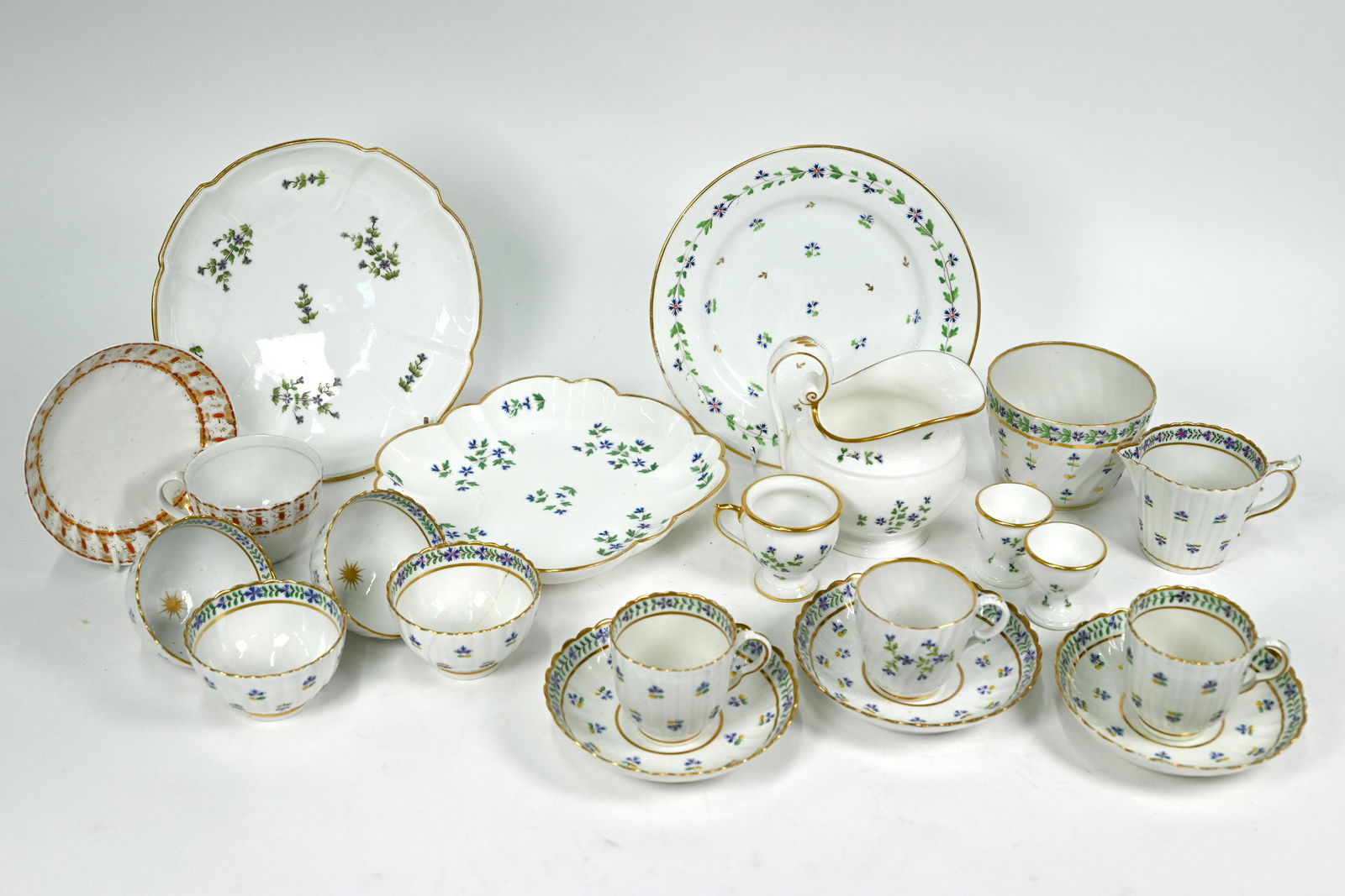 A First Period Worcester part tea service: A First Period Worcester part tea service, decorated with blue and green floral sprigs and gilding, comprising reeded milk, sugar, three coffee cups and saucers and four bowls, to/w a 19th century Con