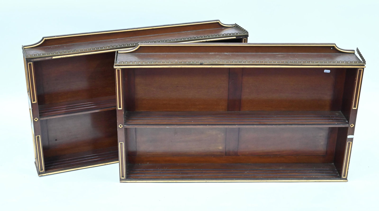 A pair of wall hanging open two tier shelves: A pair of wall hanging open two tier shelves, with pierced brass gallery tops and gilt edges, circa 1900, 92 cm w x 13 cm x 54.5 cm h (2)