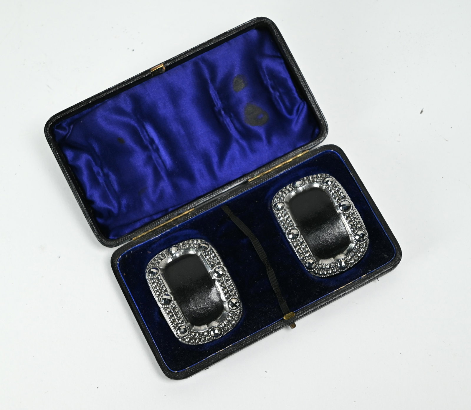 A cased pair of Georgian steel-backed leather: A cased pair of Georgian steel-backed leather shoe-buckles with polished steel marcasite surrounds, 6 x 4.5 cm (little used)