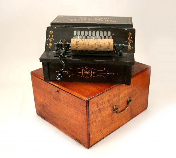 Bates Gem Roller Organ Orig Case w/Rolls 19thC: Original paint, in working order. Includes 20 rolls. Measurements: 9" tall X 15 1/2" wide X 14" deep