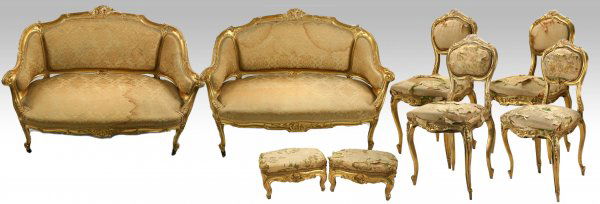 8 Pc Giltwood Parlor Furniture Suite, 19th-20thC: Eight-piece matched set, comprising a pair of settees, four chairs and two footstools, all with upholstered, with giltwood framing; foliate carved detail Measurements: Settees are each 34 1/2" tall X