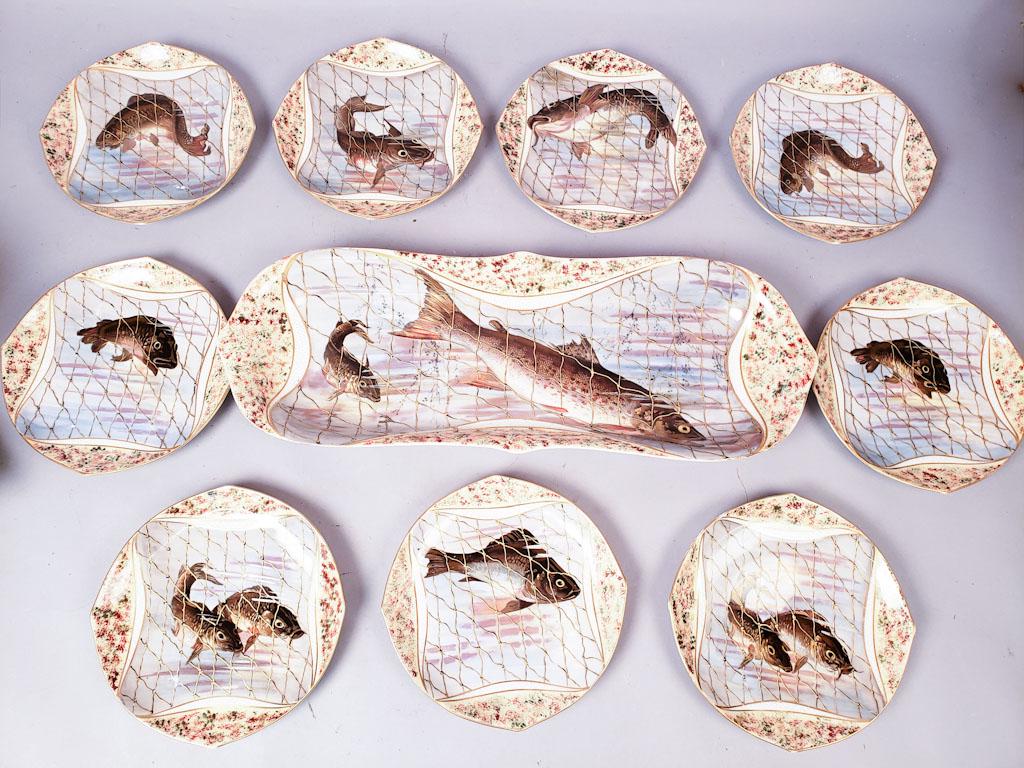 Porcelain Limoges Fish Service Set: This is a set of antique Limoges fish plates and serving platter. They feature several types of fish caught in nets. platter 23 3/4", plates 9 1/2" diameter