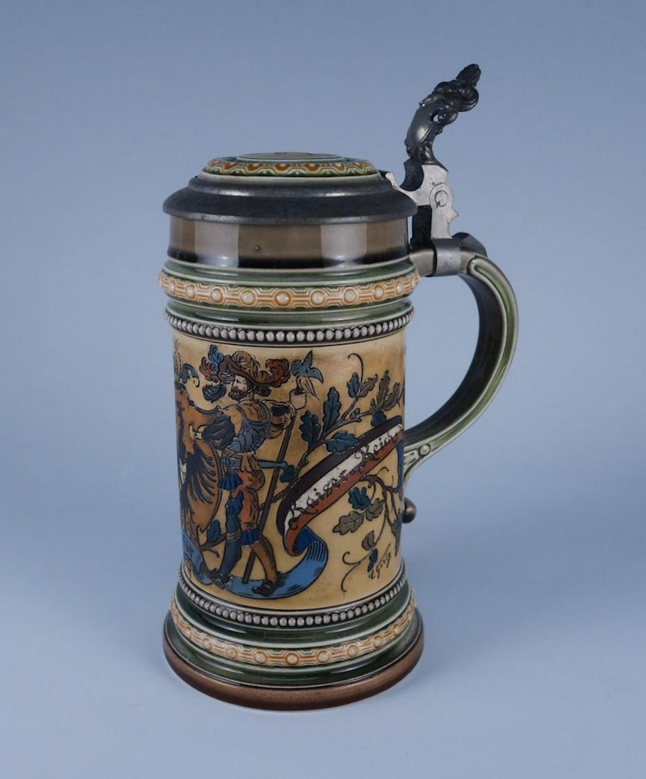Mettlach Stein #1520 Mitt Gott Fur Kaiser und Reich: This is a Mettlach 1/2 liter stein featuring an immage of two Renaissance style warriors on either side of an eagle crest. The words on the stein are "Mit Gott Fur Kaiser [a.] Reich". 8 3/4" tall with