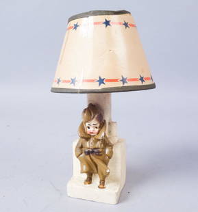 Miniature Soldier Lamp with Paper Shade: Miniature lamp with paper shade. Hand written on back "Aug 31, 194[illegible]" "Man[illegible]". 7 1/2x 2 1/4"x2"