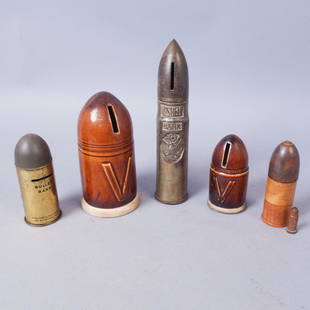 Lot of 5 WW2 Era Bullet Shell Banks: Tall metal shell bank: "1" Shell Bank,Patent Appl'd For". Short metal shell bank: "Bullet Bank [rest of patent info]". Two ceramic "V" shell banks. One wooden bank/toy with a smaller carved wooden