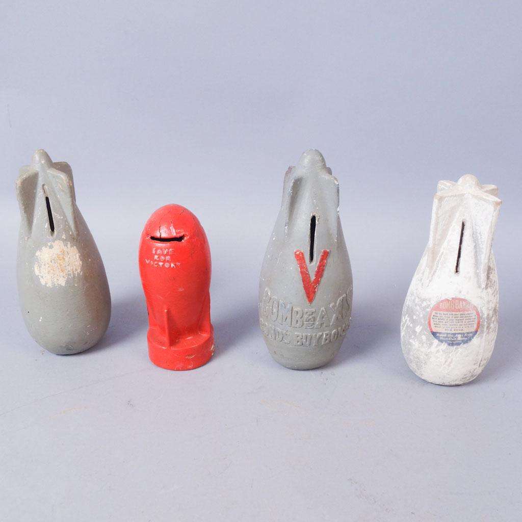 Lot of 4 WW2 Era Bomb Banks: 1 plain gray ceramic bomb bank. 1 gray ceramic bomb bank marked "V" "Bomb The Axis Bonds Buy Bombs" V is painted red. 1 red bank with "Save For Victory" on opposite sides. Marked with a patent on base
