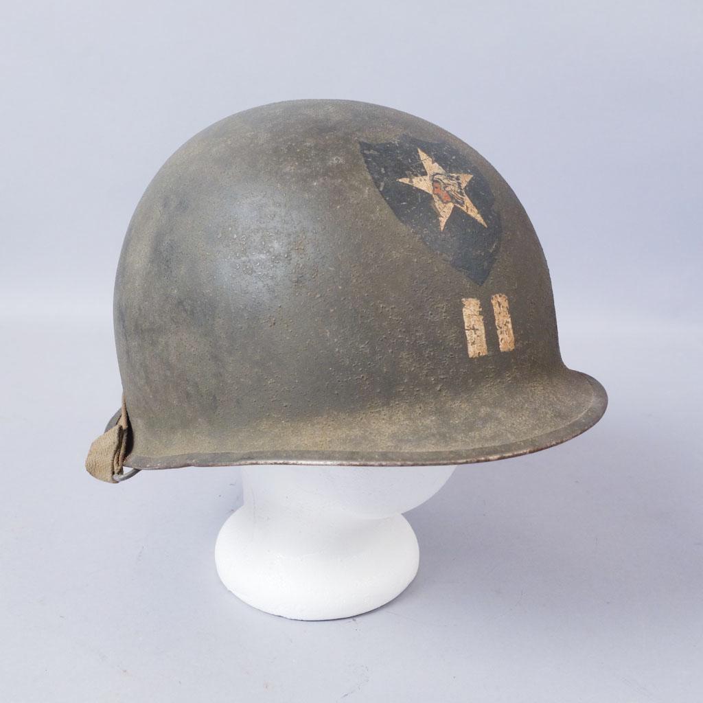 WW2 US Army 2nd Infantry Division Helmet: US Corporal helmet from the 2nd Infantry Division. The helmet is painted with a Native American figure head in a star on a shield. Inside marked "7013". 11 1/8"x9 3/4"