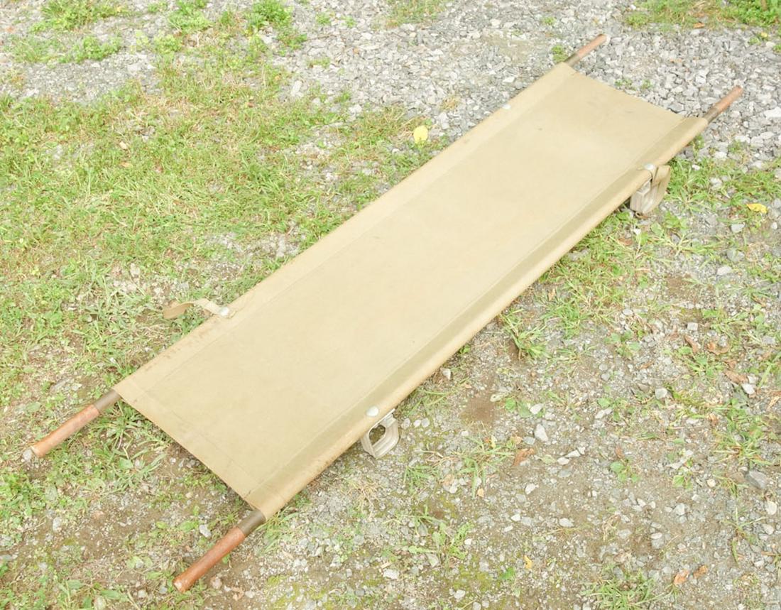 US Army Stretcher: Canvas stretcher with wooden carrying poles "Mine Safety Appliances Co. Pittsburgh, PA U.S.A." written on canvas. 90"x21 1/2"