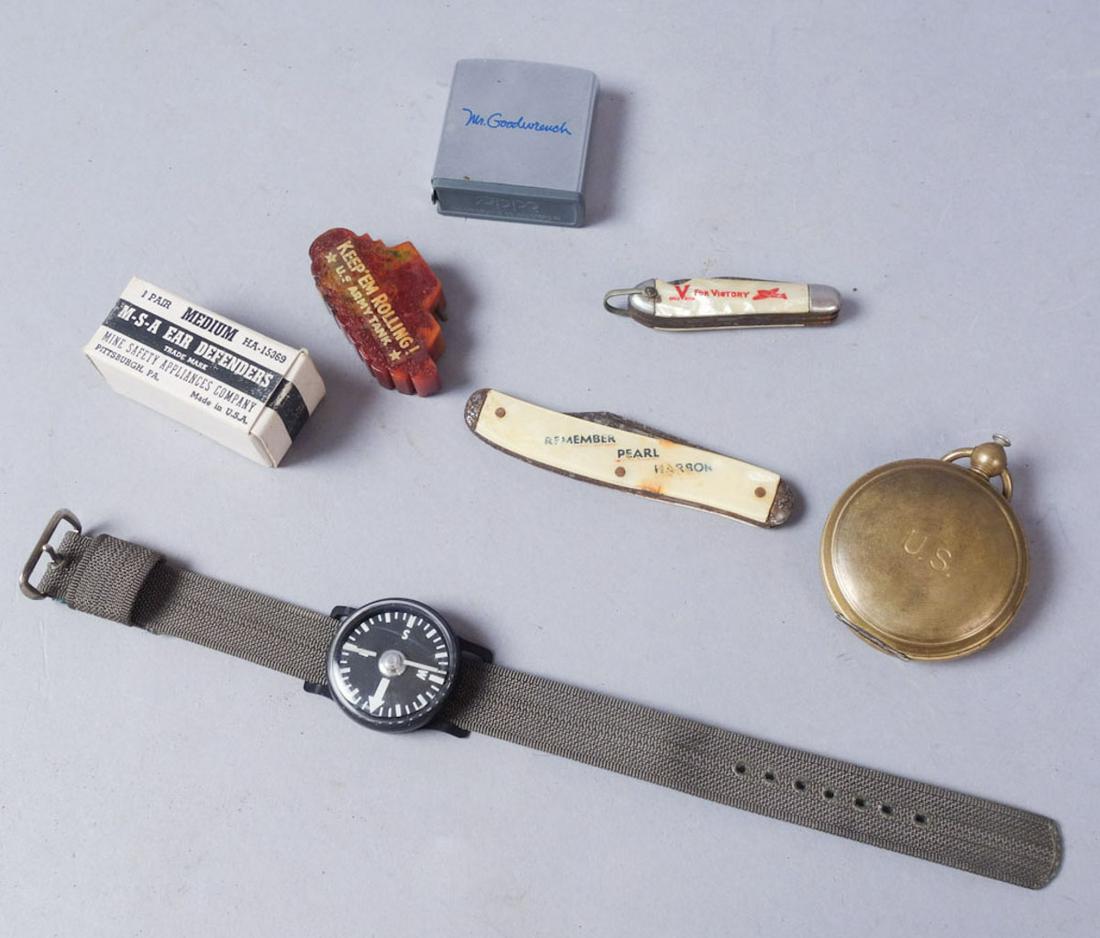 Lot of WW2 Civilian Goods incl. Pocket Knives: Two pocket knives, one pencil sharpener, one pocket watch case compass, one Zippo brand "Mr. Goodwrench" tape measure, one plastic wristband compass with nylon strap, and one set of Ear Defender brand