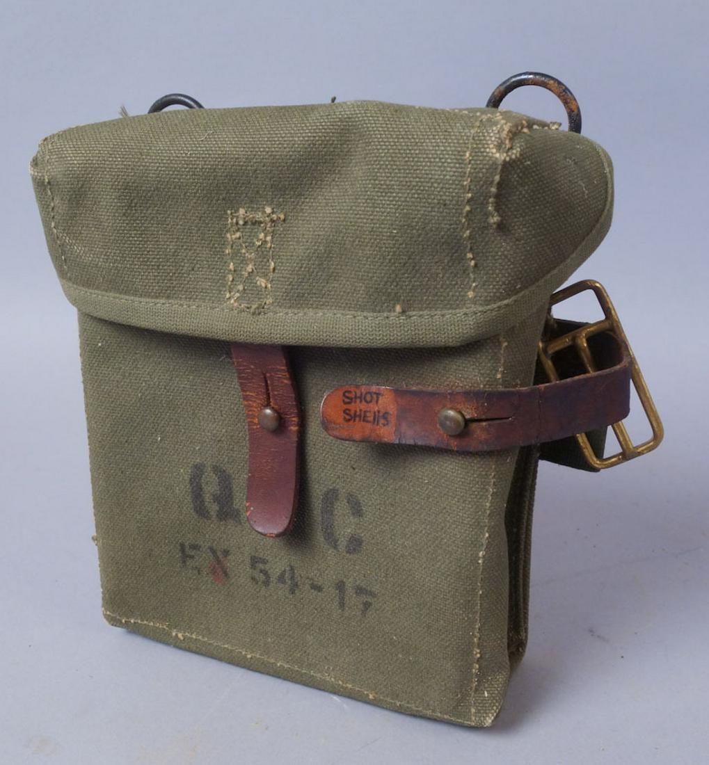Canvas Shotgun Shell Case: Canvas case with metal inserts on front and reverse. Leather strap marked "Shot Shells" on right side. Unknown brass slide on marked leather strap. 6 1/2"x8"