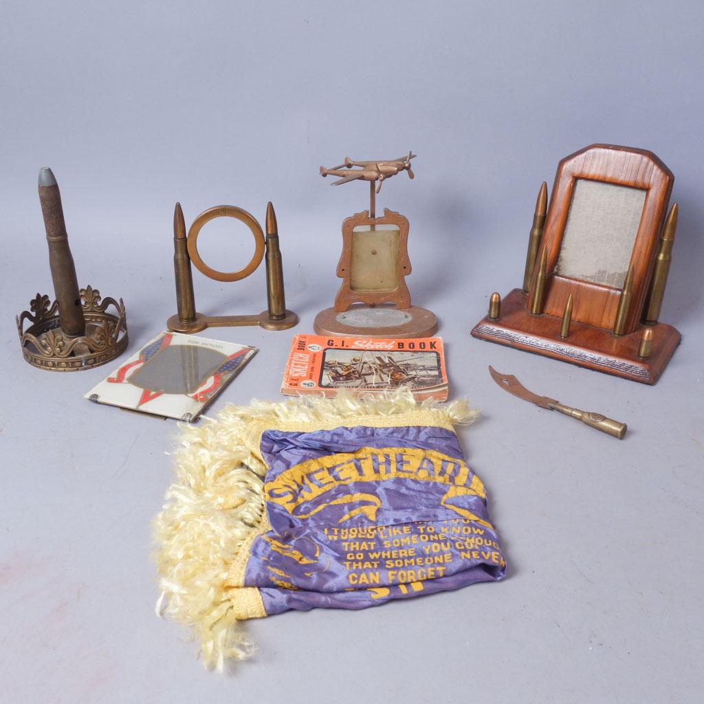 Lot of WW2 Memorabilia incl. Trench Art, Handkerchief: 2 frames featuring bullet-like decoration. 1 frame featuring an airplaine with moving propellers. 1 trench art object. 1 "V for Victory" frame. 1 trench art letter opener knife with "C AU Thierry" mar