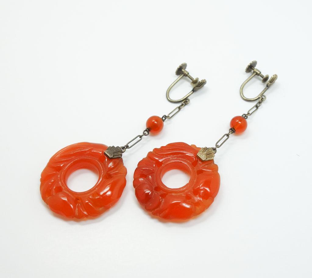 14k Gold Art Deco Chinese Carnelian Bi Disk Earrings: This is an unusual pair of Chinese Art Deco earrings dating to the early 20th century. Rendered in fine 14k gold, these earrings feature large hand carved carnelian Bi Disks. These dangle earrings hav