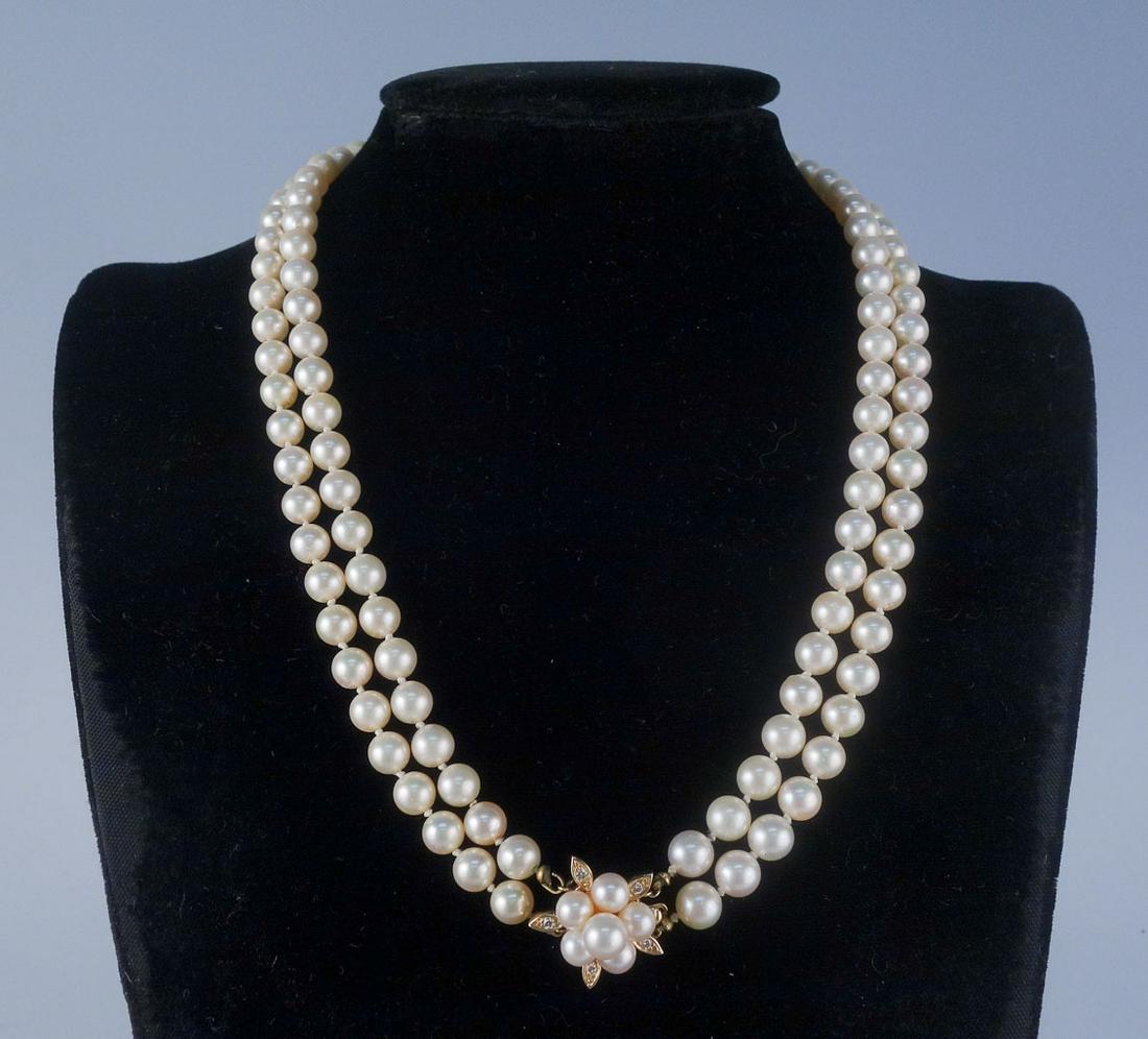 Double Strand 20" 7.5mm Pearl 14k Diamond Clasp: This is a double strand pearl necklace princess length. Strung with silk and rendered in fine 14k gold, this necklace features 5 diamonds surrounding a cluster of 6 pearls. The clasp is stamped "H" an