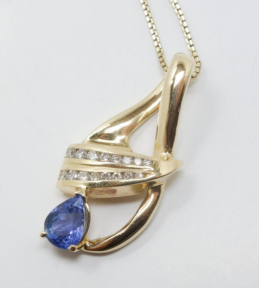 14k Yellow Gold Diamond Tanzanite Pendant Necklace: This is a fine diamond tanzanite necklace. Rendered in fine 14k yellow gold, it features two rows of 8 diamonds and a teardrop tanzanite in a 3 prong setting. The necklace and clasp are both marked fo