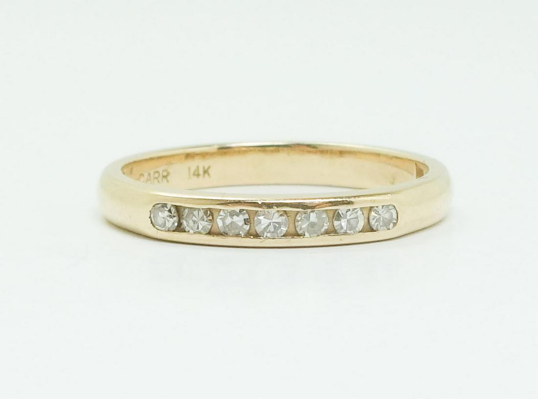 Vintage 14k Yellow Gold Diamond Band Anniversary Ring: This is a vintage anniversary ring. Rendered in fine 14k yellow gold, it features 7 diamonds in a row. The inside of the band is stamped "Carr" and 14k. This ring weighs a total of 2.4g. The ring is a