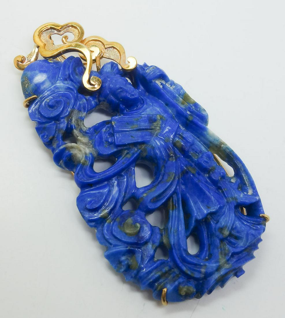 Vintage Lg Carved Lapis Lazuli 14k Yellow Gold Pendant: This is a vintage lapis lazuli pendant. Rendered in fine 14k yellow gold, this piece shows a robed figure holding books or scrolls surrounded by swirling winds. The front of the gold setting is shaped
